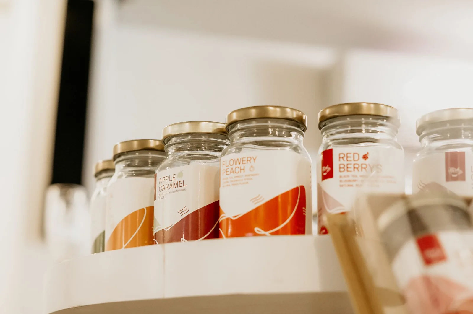 Two labeled spice jars side by side on a kitchen shelf
