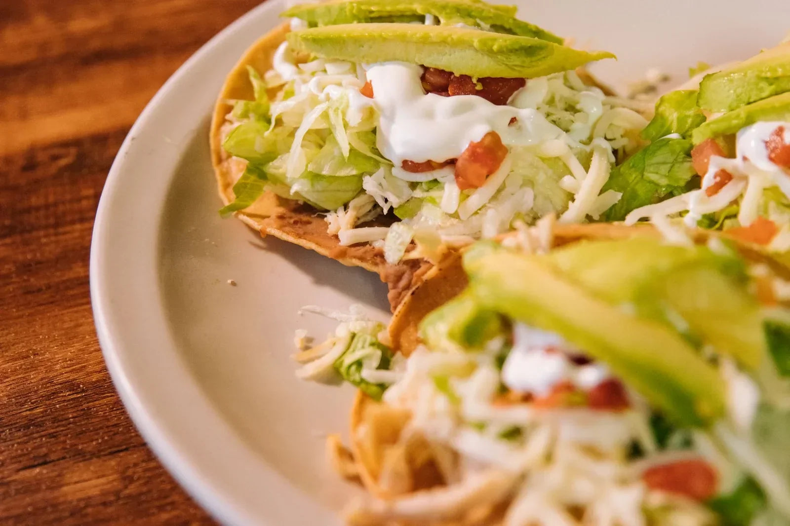 Shredded chicken tacos seasoned and plated with fresh toppings